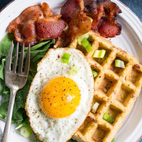 Bacon frying in stove top pan. Sizzling bacon strips in silver skillet.  Stock Photo